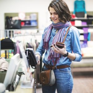 Woman in Clothing & Apparel Store Using POS